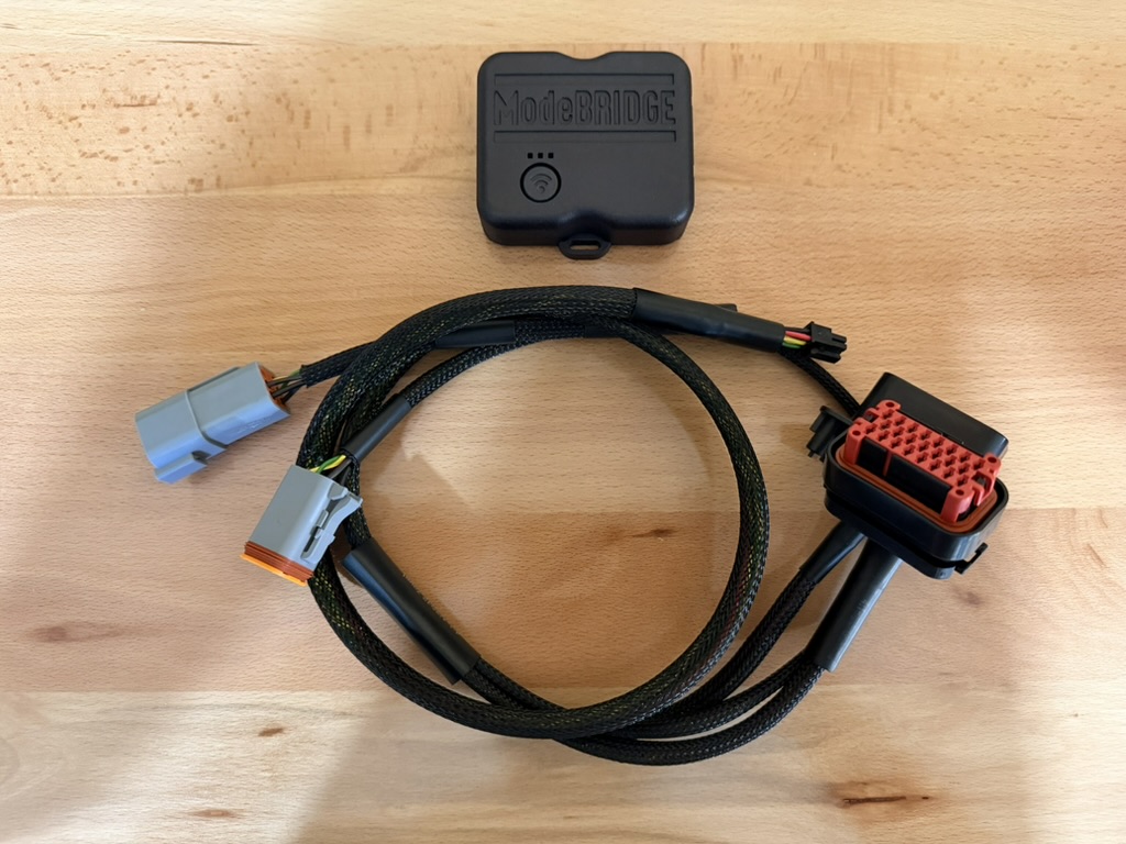 The ModeBRIDGE controller and its plug-and-play harness, with keyed connectors on both ends.