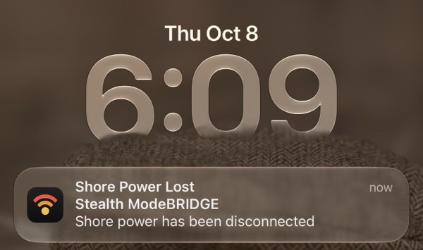 An iPhone lock screen notification from ModeBRIDGE reading 'Shore Power Lost — Stealth ModeBRIDGE shore power has been disconnected.'